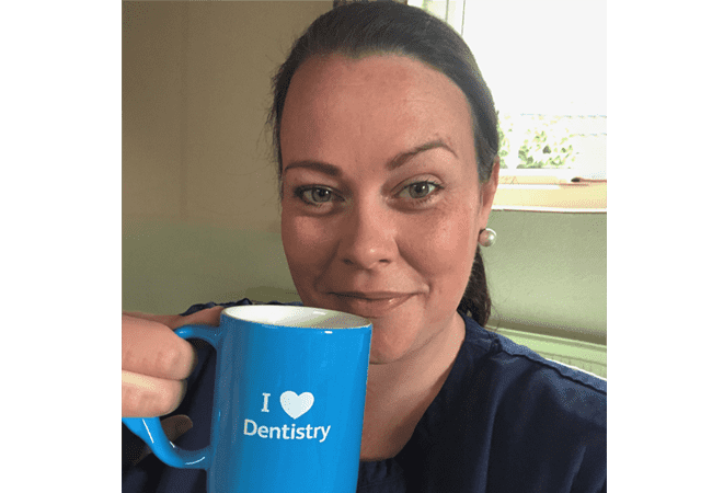 Hannah Woolnough 650x450 Hannah Woolnough holds a cup saying 'I heart dentistry'