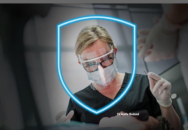 Indemnity ad - Dr Aoife Boland Dr Aoife Boland is wearing face protection while treating a patient. She is also protected by a blue shield